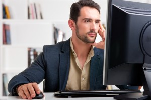 Man Looking At A Computer Monitor